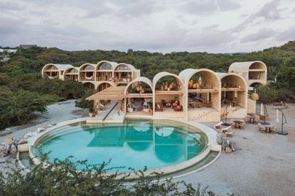 View of a pool from the outside of the hotel