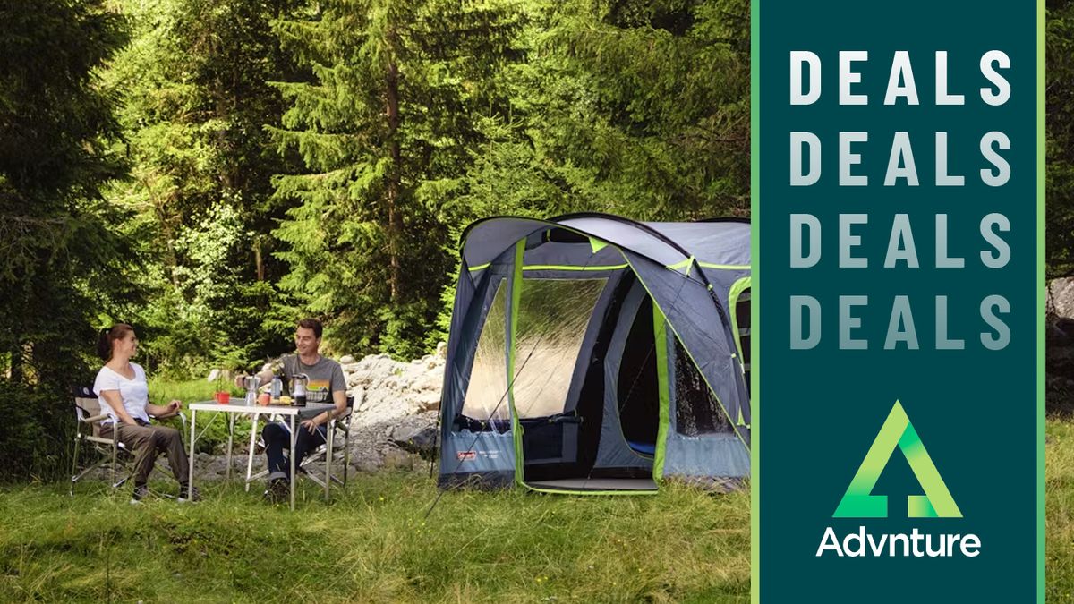 Couple sitting at table outside tent