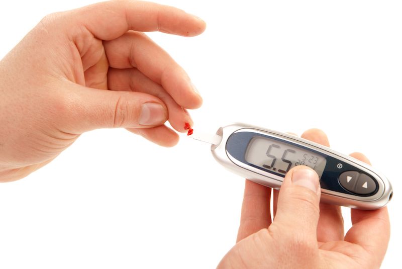 A person with diabetes checks their blood glucose level. 