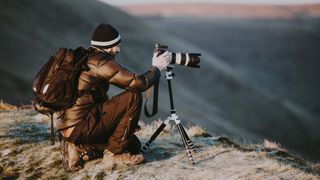Photographer using a camera on a tripod