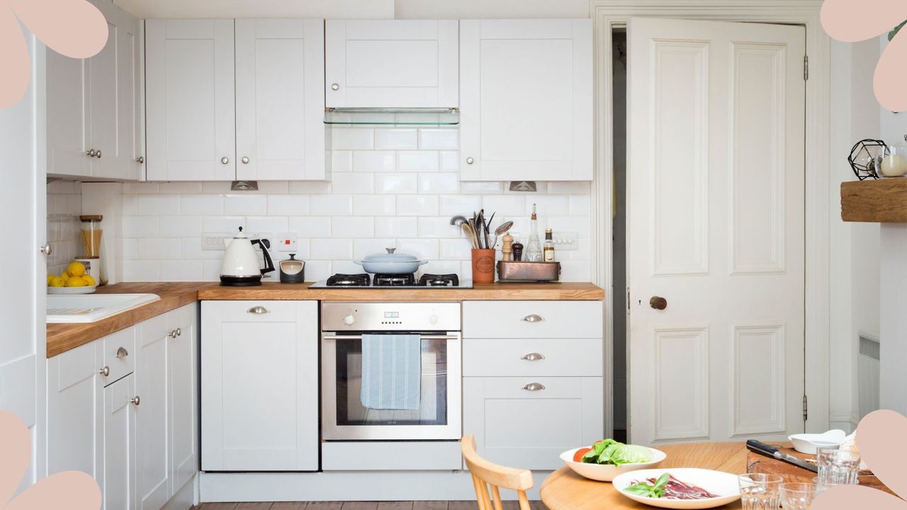 picture of neutral kitchen with grey cabinets and a wooden dining table with food on it 