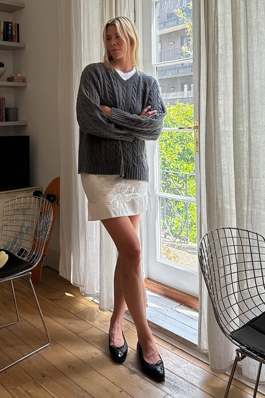 a woman wearing a gray sweaterboots