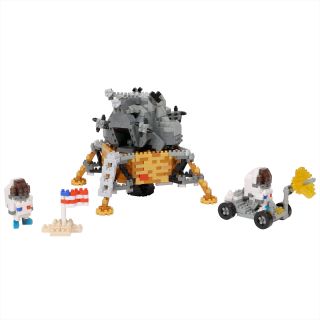 Image of the 1,360-piece Nanoblock Apollo lunar module and two spacesuited toy astronauts, one of which is driving a lunar roving vehicle.