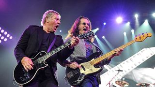 Alex Lifeson (left) and Geddy Lee perform onstage with Rush in 2013