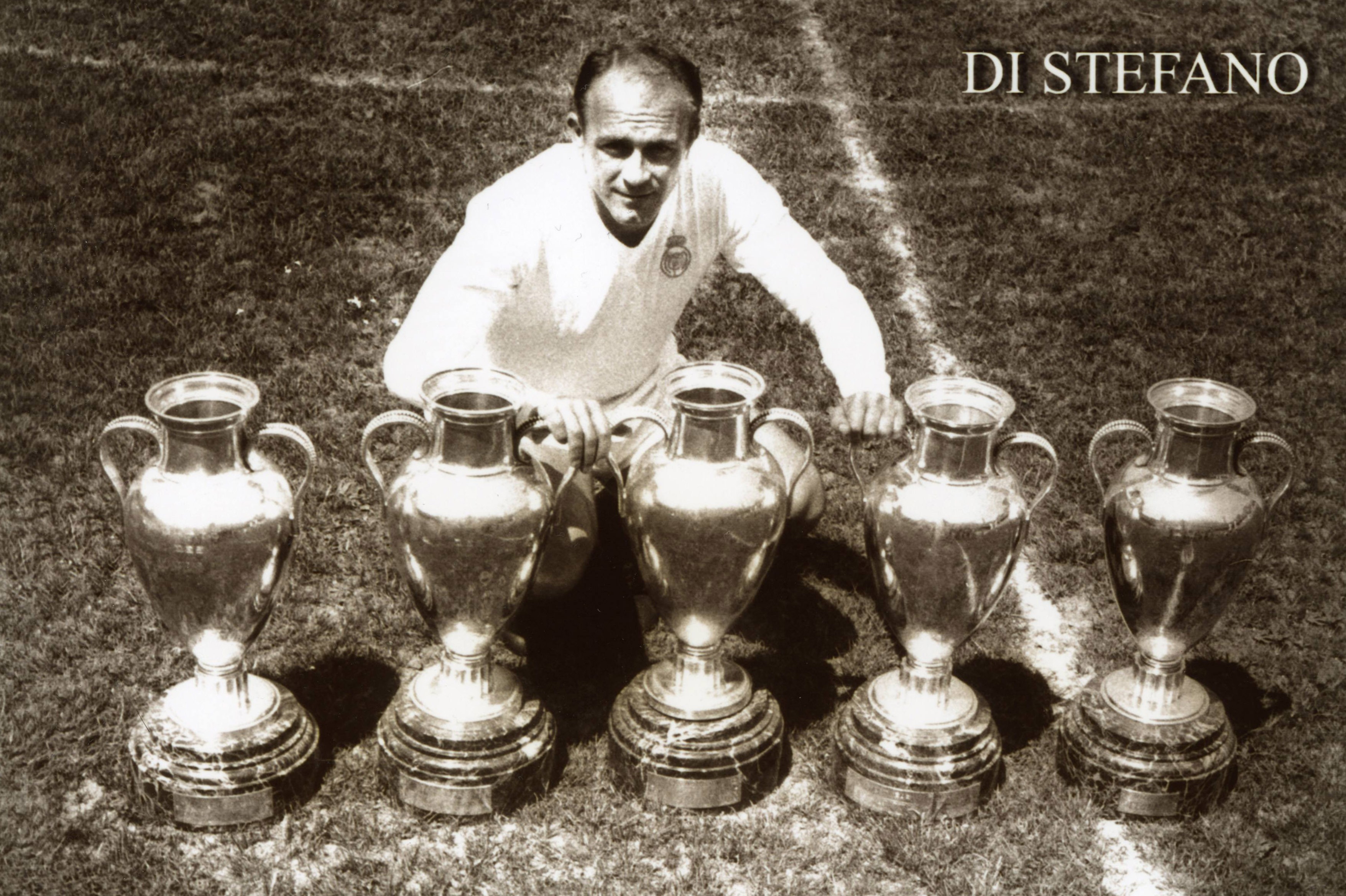 Alfredo Di Stefano poses with the European Cup trophies he won as a Real Madrid player.
