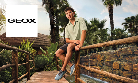 Man sat on wooden fence outside with geox logo in top left corner