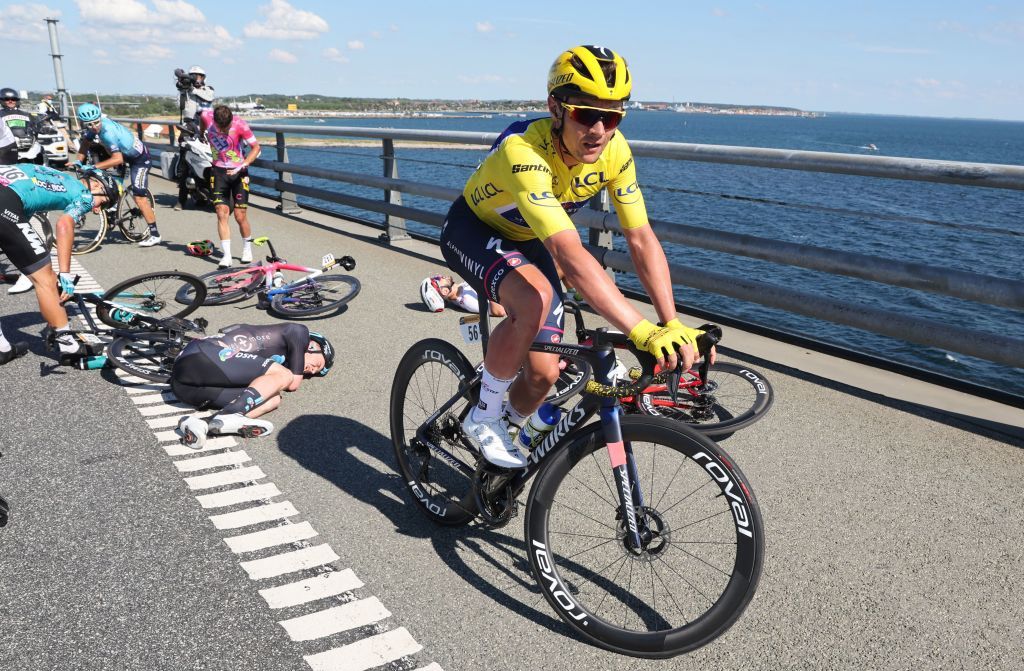 QuickStep Alpha Vinyl Teams Belgian rider Yves Lampaert wearing the overall leaders yellow jersey mounts his bicycle after suffering a crash with Totalenergies teams French rider Anthony Turgis EF EducationEasypost teams Portuguese rider Ruben Antonio Almeida Guerreiro and BB HotelsKTM teams Italian rider Luca Mozzato on a bridge in the final kilometers of the 2nd stage of the 109th edition of the Tour de France cycling race 2022 km between Roskilde and Nyborg in Denmark on July 2 2022 Photo by Etienne GARNIER POOL AFP Photo by ETIENNE GARNIERPOOLAFP via Getty Images