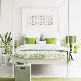bedroom with white wall and green bed lamp and pillows