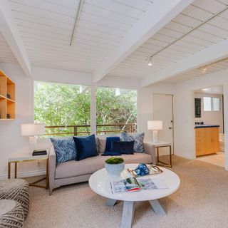 room with white wall and open shelves