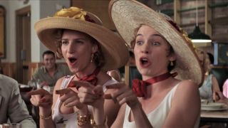 Rachel Griffiths and Carrie Preston wear large hats as they sing "I Say a Little Prayer" in My Best Friend's Wedding.