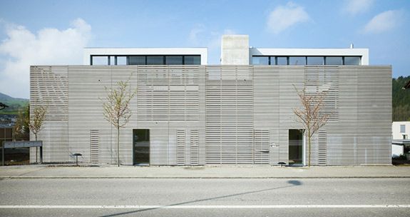 The Magden apartments are swathed in wooden slats, with courtyards and expanses of glass within.