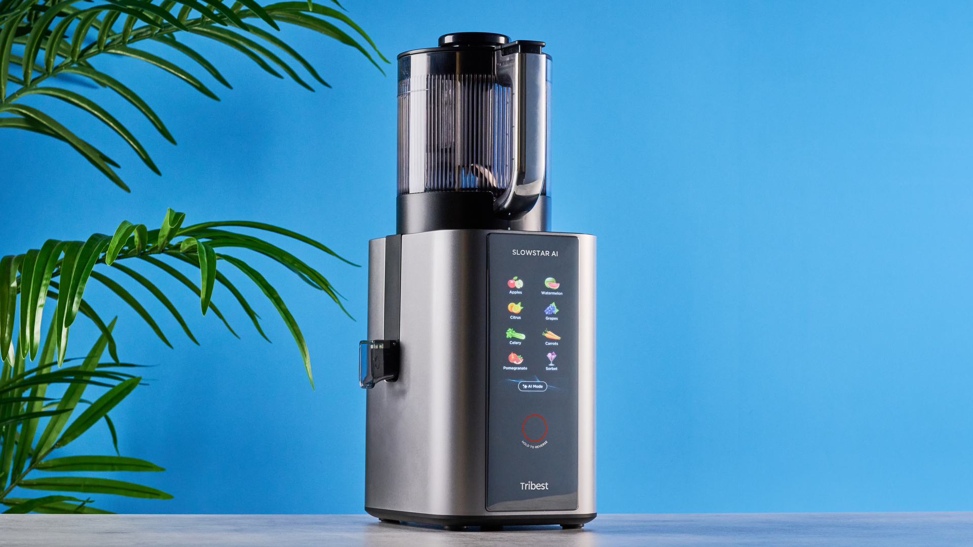 Tribest Slowstar AI Vertical Hopper Juicer photographed in front of a blue background