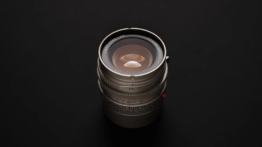 The Light Lens Lab 35mm f/1.4 Aspherical "11873" lens on a black studio background