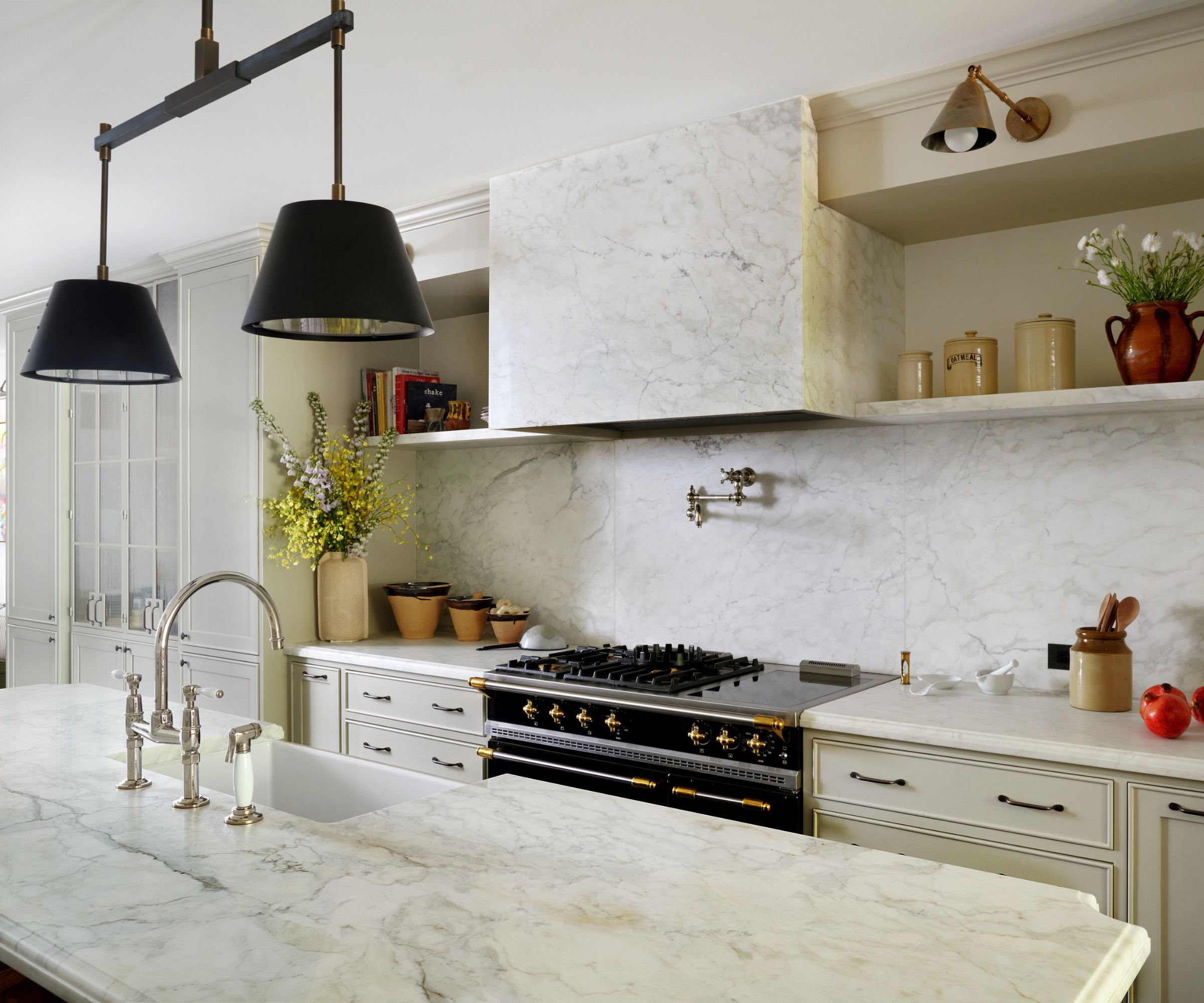 modern kitchen with marble counters and wall and neutral cabinets