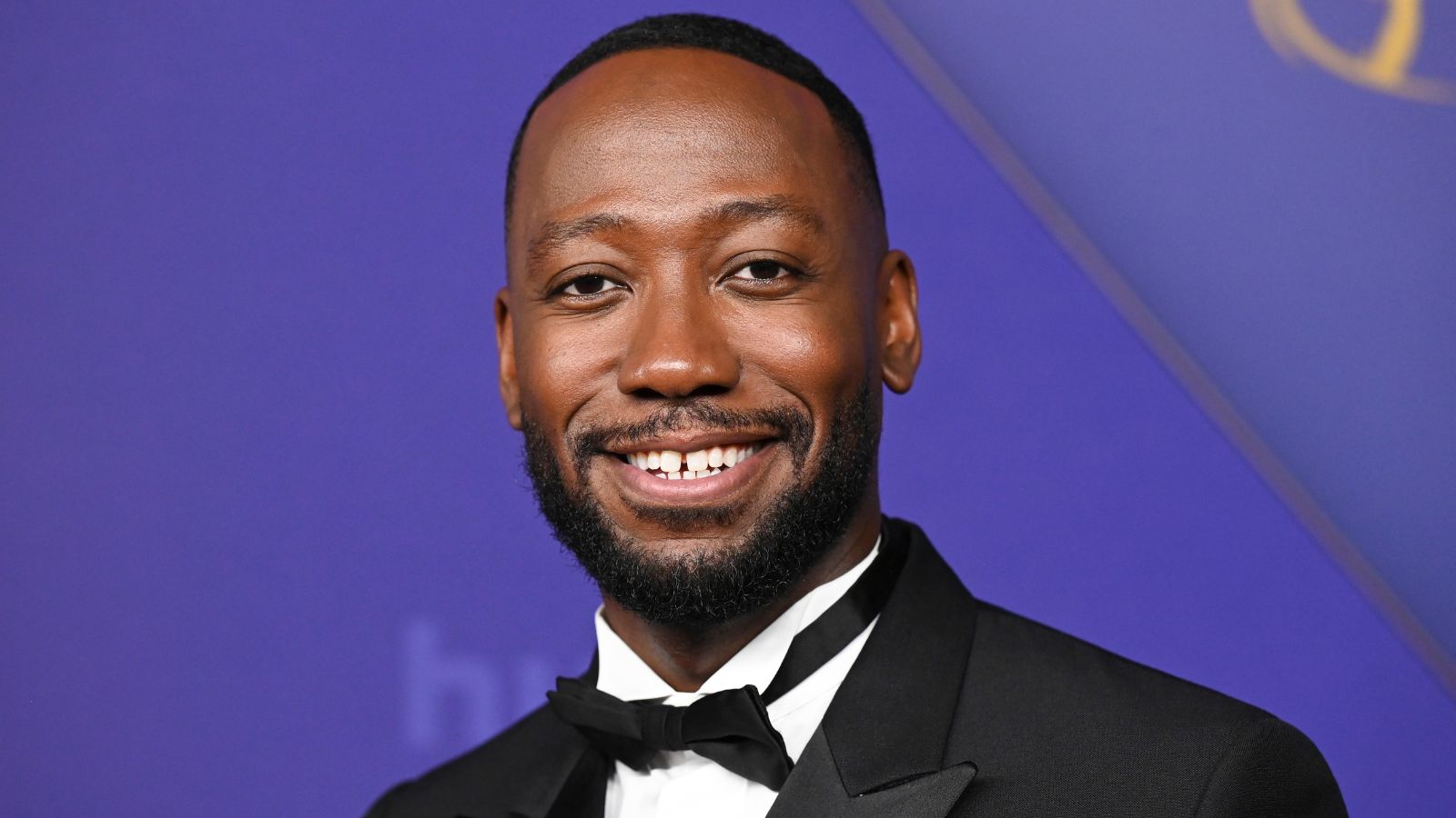 Lamorne Morris' pool features lush greenery, light patio furniture, and blue tiles for a Mediterranean style that is easy to recreate