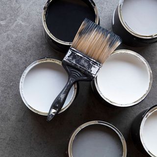 black and white paint container with brush