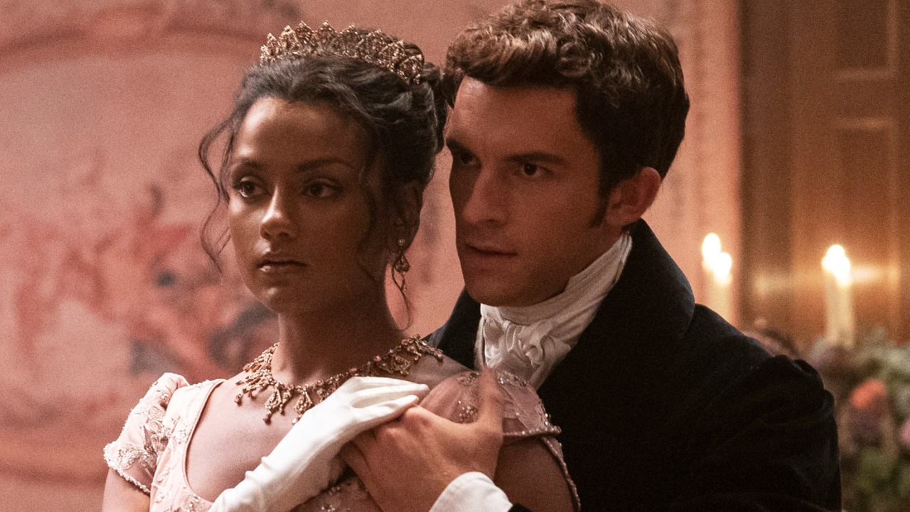 Simone Ashley and Jonathan Bailey stand while holding hands in Bridgerton Season 2.