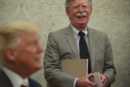 Bolton laughs behind Trump