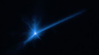 telescopic image of blue dust rising from an asteroid