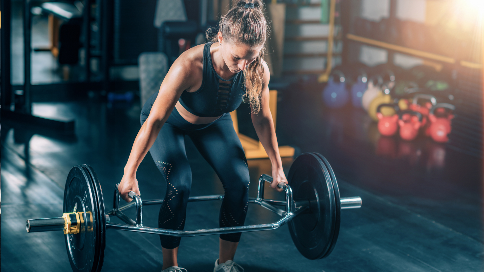 Woman doing trap bar deadlift