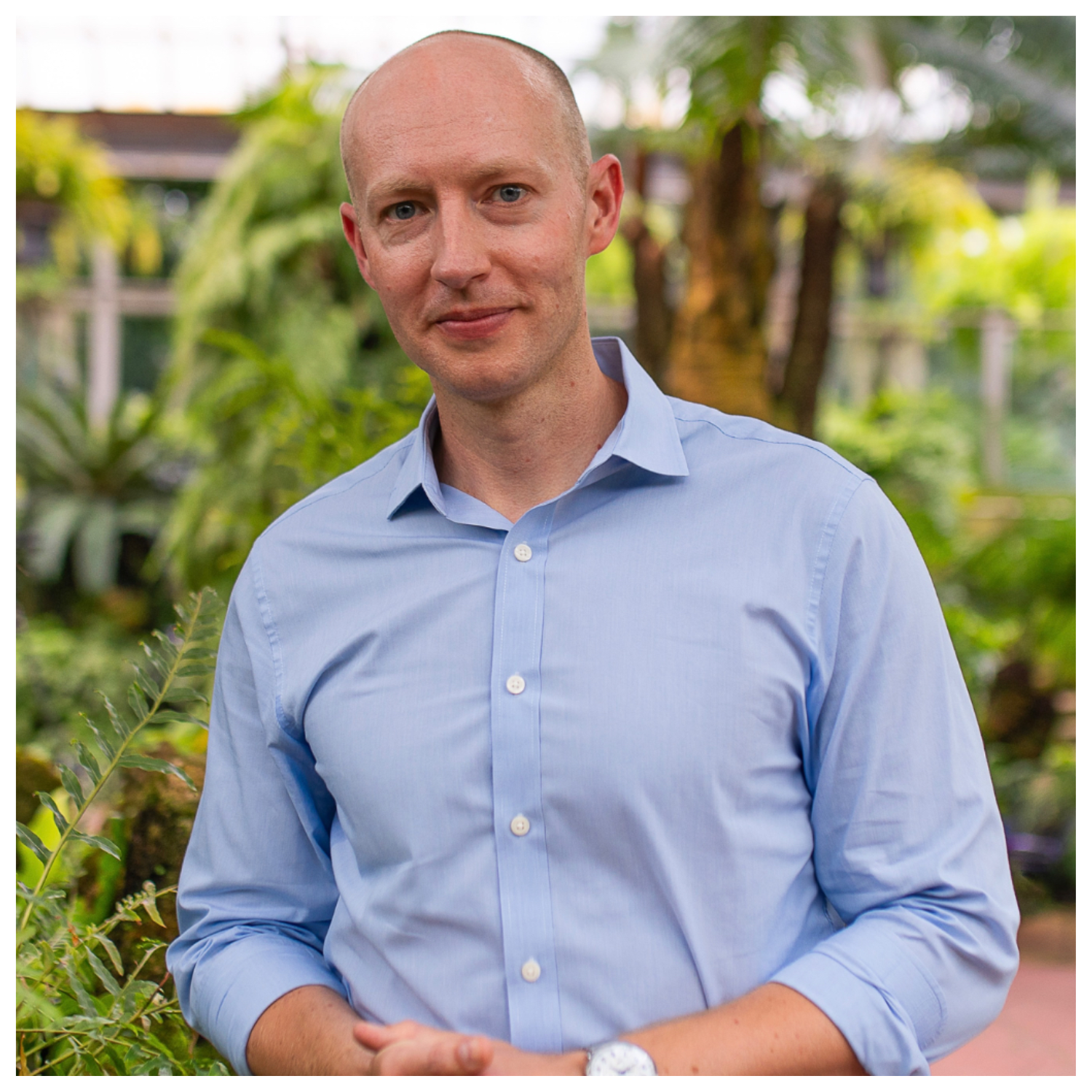 A headshot of James Mastaler in an outdoor garden