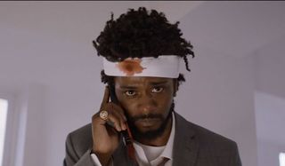 Lakeith Stanfield using a cell phone with a head wound in Sorry to Bother You