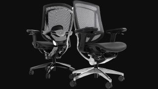 A pair of NeueChair office chairs on a black background