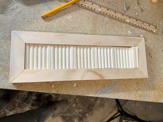 A drawer front in the process of being renovated with fluted molding