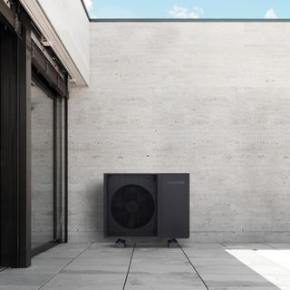 black air source heat pump outside contemporary house
