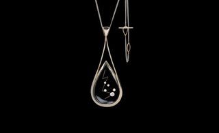 Pendant in white gold and crystal, with five inlaid diamonds