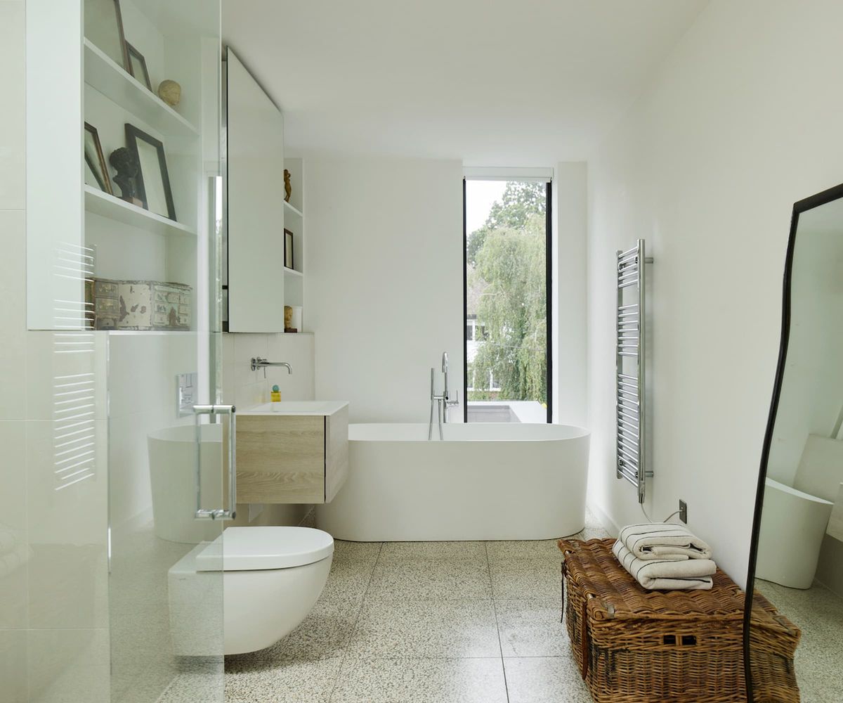 A white bathroom with a white bath