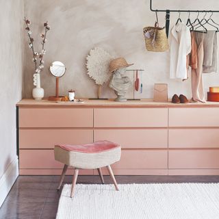 A pink IKEA chest of drawers used as a vanity