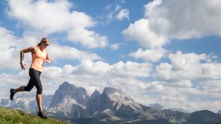 A woman running through the mountains