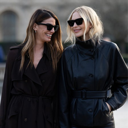 Two women smiling at paris fashion week with sunglasses on