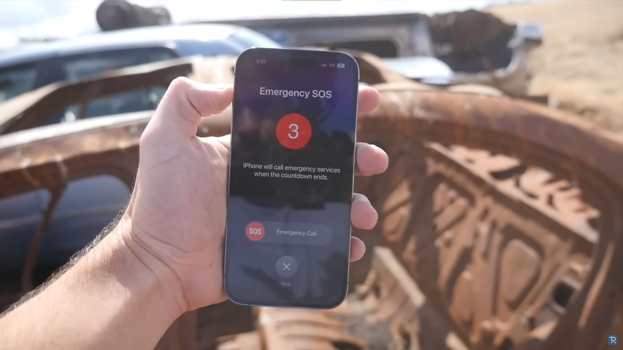 An image of an iPhone 14 Pro showing an emergency SOS notification after a simulated car crash