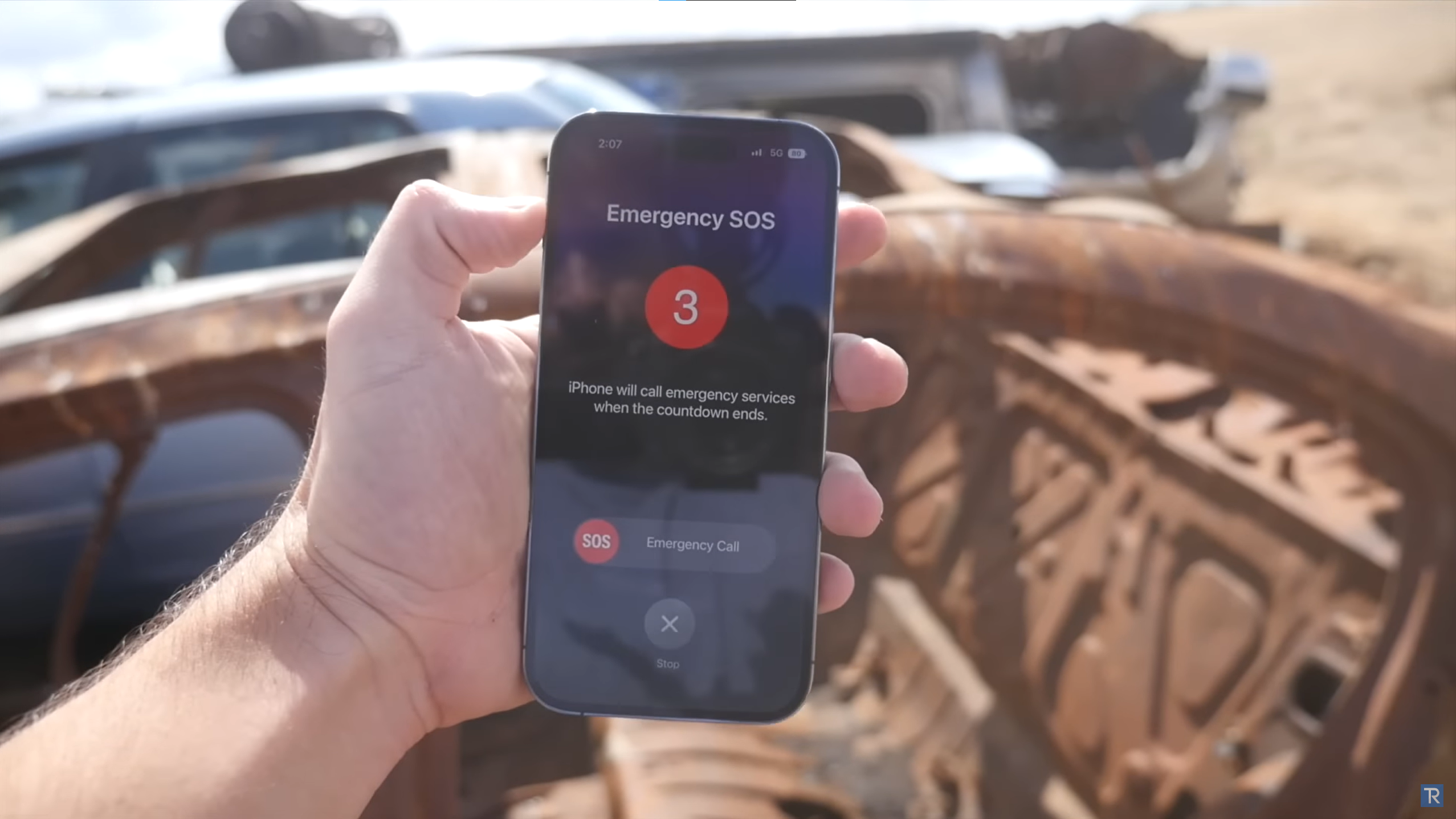 An image of an iPhone 14 Pro displaying an emergency SOS notification after a simulated car accident