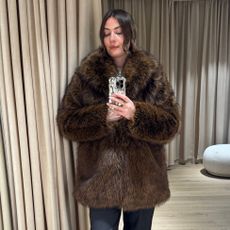 Sophie Robyn Watson wearing an fluffy brown H&M coat.