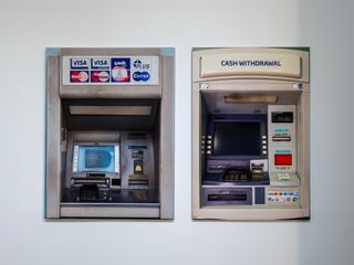 photos of atms on white wall in gallery