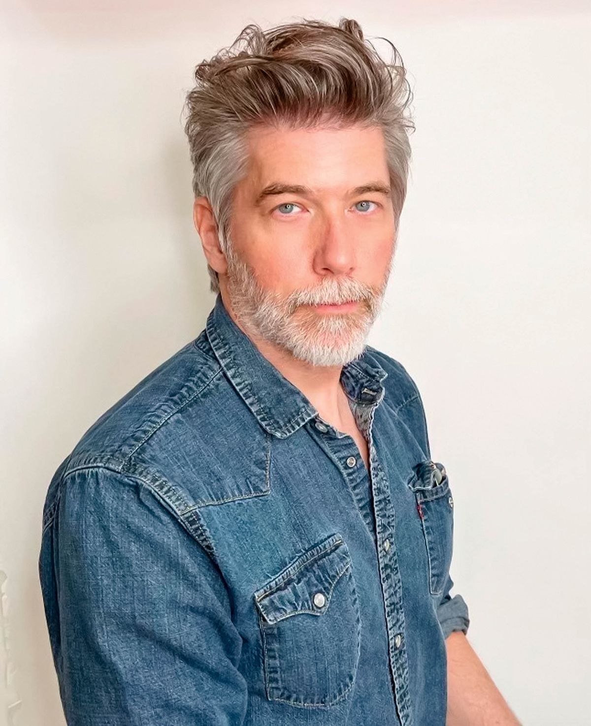 A portrait of Rick Heins, senior product manager, Fender, wearing a denim shirt.