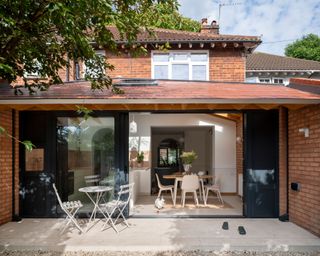 large rear brick extension with sliding doors and overhang