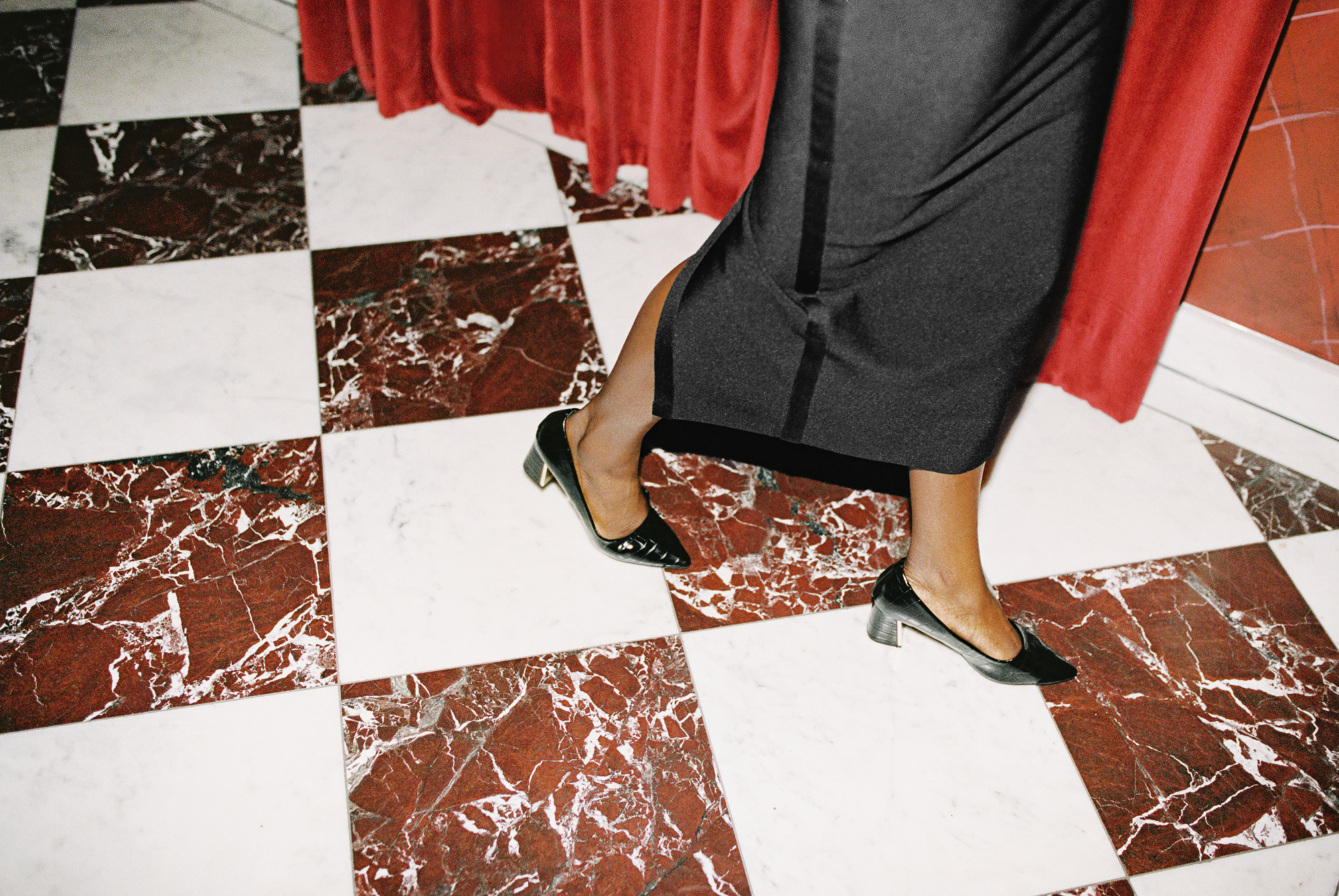 Woman&#039;s feet as she walks across chequered floor of Carbone restaurant in London