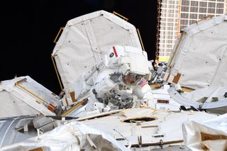 NASA astronaut Anne McClain waves during a spacewalk outside the International Space Station on March 22, 2019.