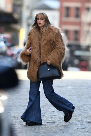 Suki Waterhouse sporting a camel brown faux fur coat from The Frankie Shop.