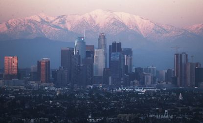 Snow-capped mountains behind downtown Los Angeles.