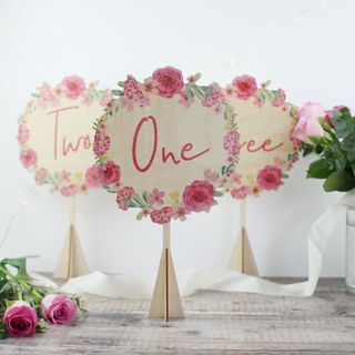 wedding wreath numbers and pink roses on table