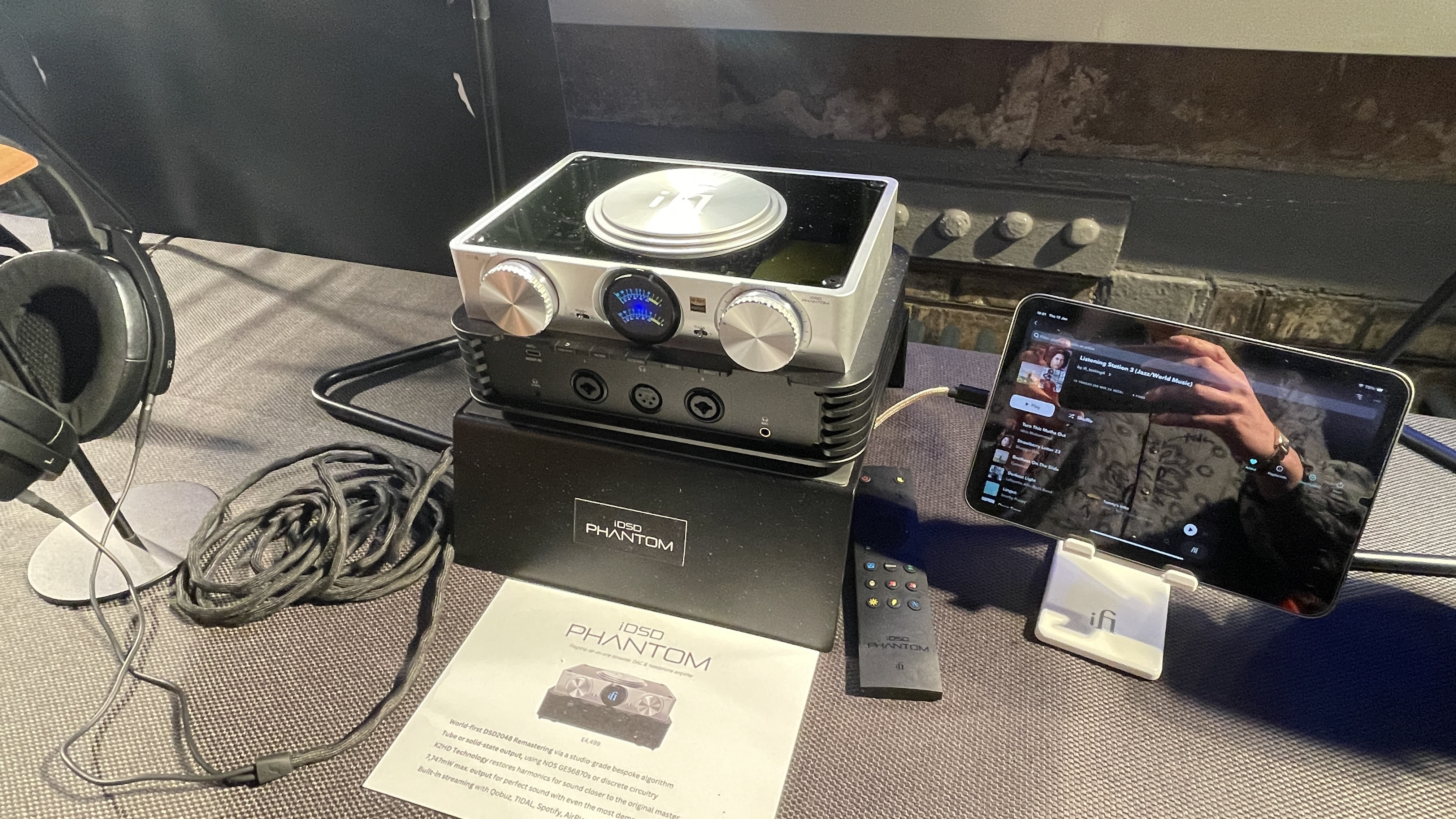 The formidable iFi iDSD Phantom in Tower Bridge, London, used with headphones and illuminating the front panel 