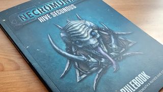 The Necromunda: Hive Secundus rule book on a wooden table