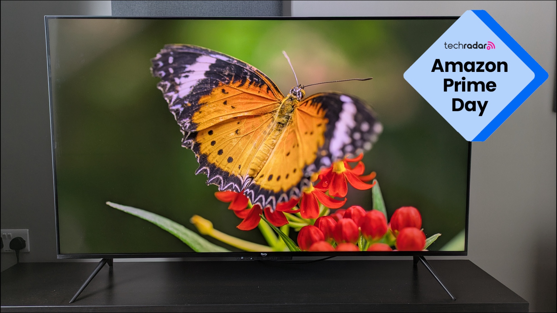 Amazon Ember Mini-LED showing orange butterfly on screen with Prime Day logo in top-left corner 