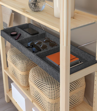 A wooden IKEA IVAR unit with a felt shelf organizer insert