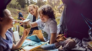 Close up of a young family camping in the forest